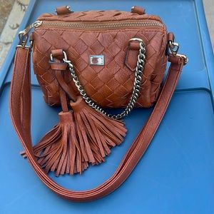 Brown small leather bag with chain straps.